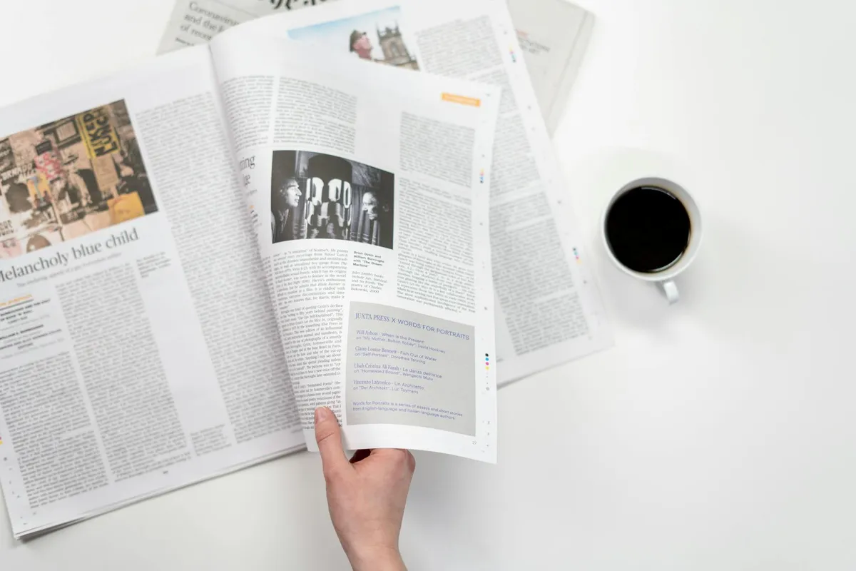 A morning workspace with newspaper and coffee on a clean desk